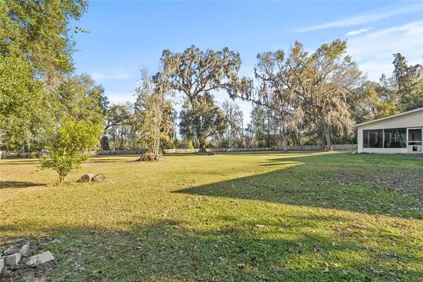 a view of outdoor space with swimming pool and green space