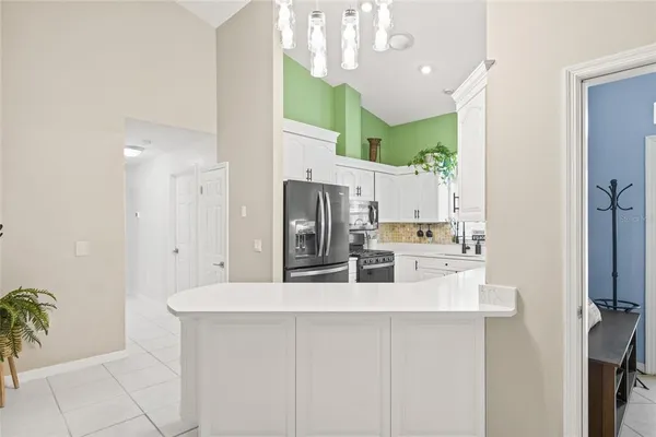 a kitchen with cabinets appliances a sink and a window