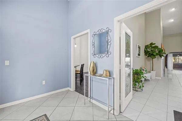 a kitchen with a table chairs refrigerator and cabinets