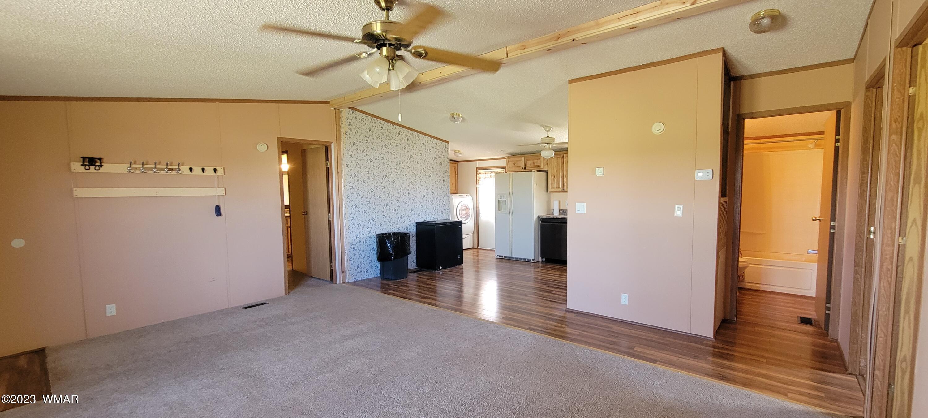 4732 Norris Road Snowflake, AZ 85937 - Photo 5 of 67 a view of a hallway with a white cabinet and a refrigerator