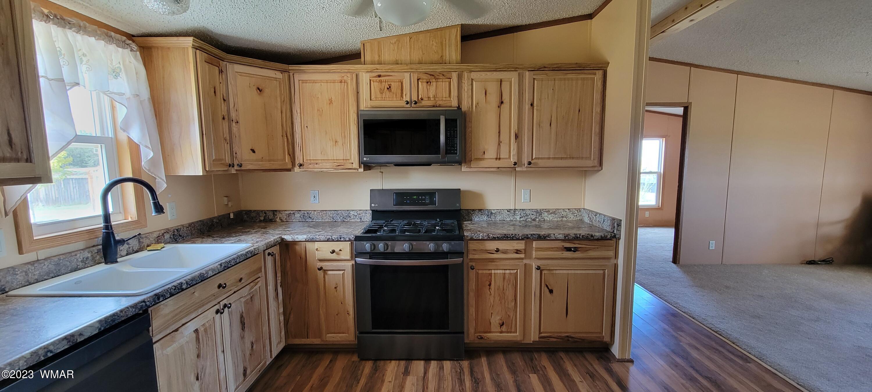 4732 Norris Road Snowflake, AZ 85937 - Photo 9 of 67 a kitchen with stainless steel appliances granite countertop a stove and a sink