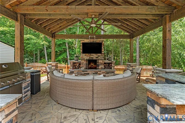 a view of a patio with couches chairs and a wooden floor