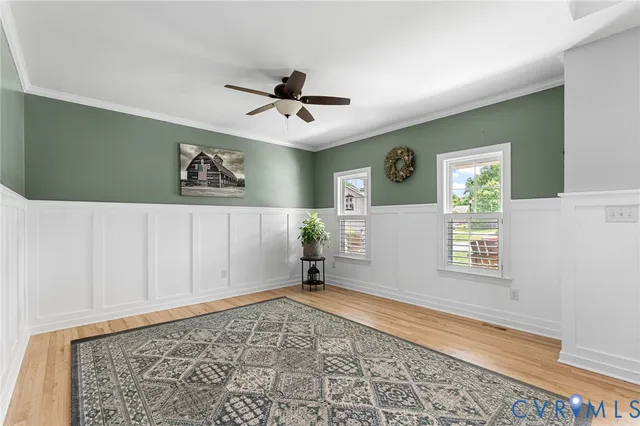 a view of empty room with window and ceiling fan