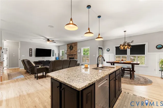 a living room with furniture a flat screen tv and kitchen view