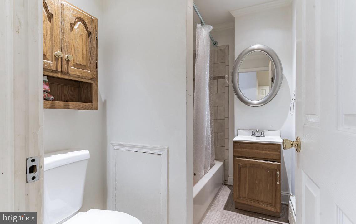 220 South 53rd Street Philadelphia, PA 19139 - Photo 12 of 15 a bathroom with a toilet a sink and a mirror
