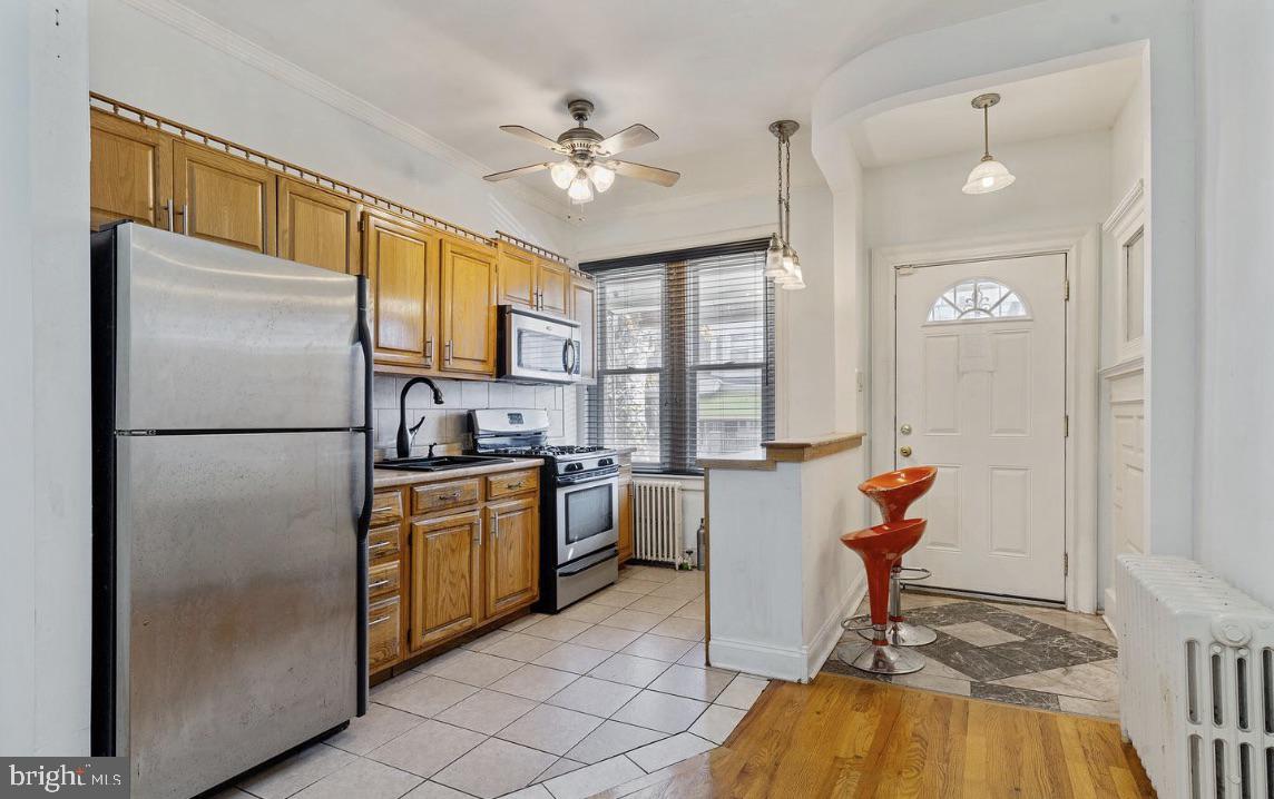 220 South 53rd Street Philadelphia, PA 19139 - Photo 3 of 15 a kitchen with refrigerator a stove and a sink