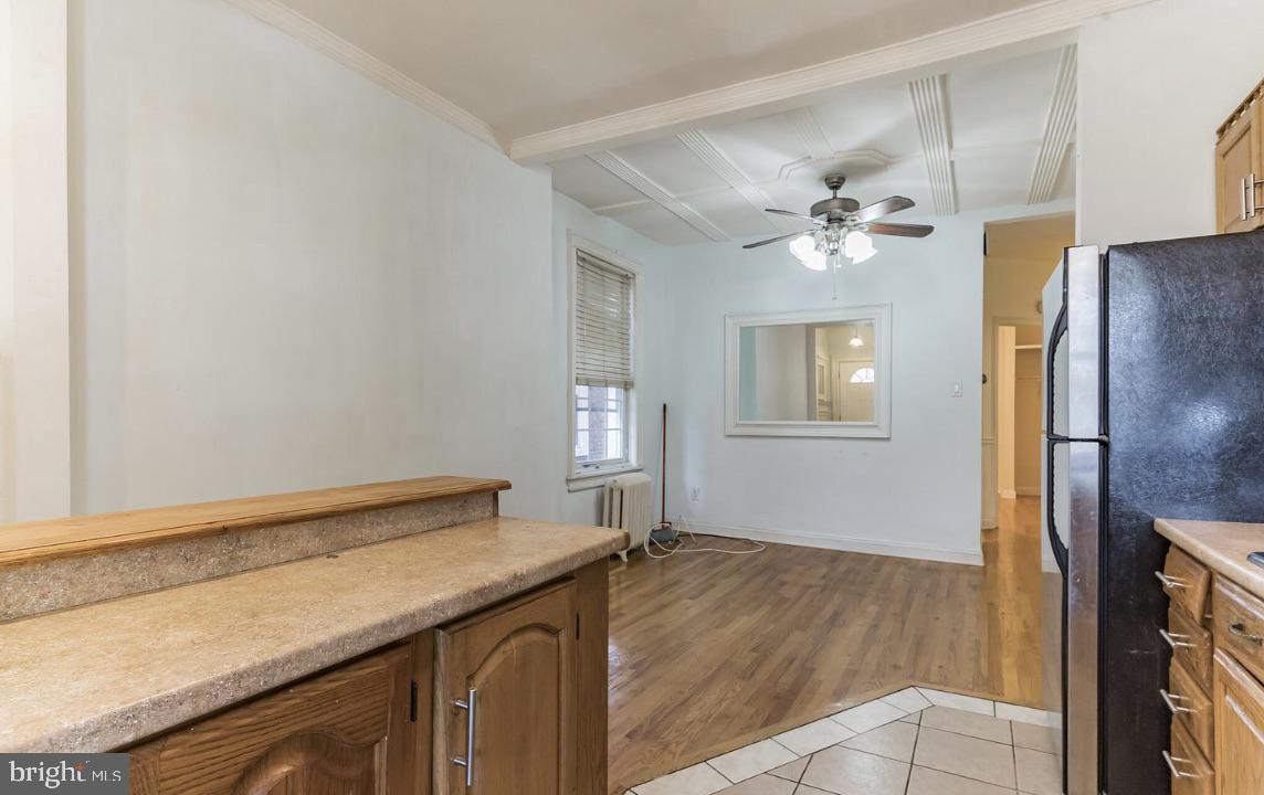 220 South 53rd Street Philadelphia, PA 19139 - Photo 5 of 15 a view of a kitchen with wooden floor and a chandelier fan