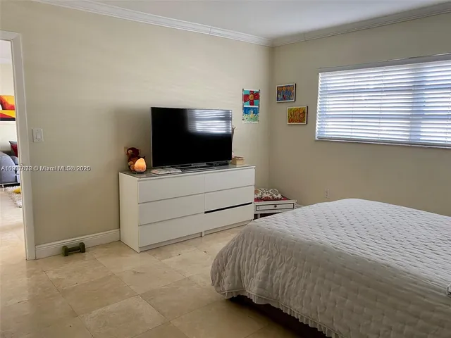 a bedroom with a bed and flat screen tv