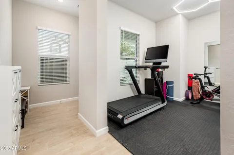 a open kitchen with stainless steel appliances granite countertop a stove top oven a sink dishwasher a dining table and chairs with wooden floor