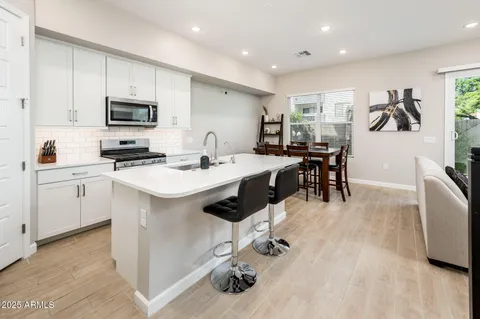 a kitchen with a sink appliances and cabinets