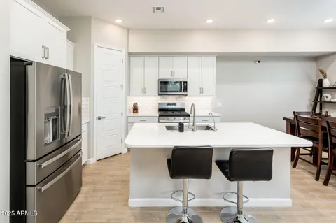 a view of a hallway with a livingroom and furniture