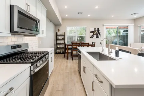 a spacious bedroom with a bed a couch and a flat screen tv