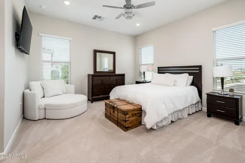 a large bed sitting in a bedroom next to a cabinet