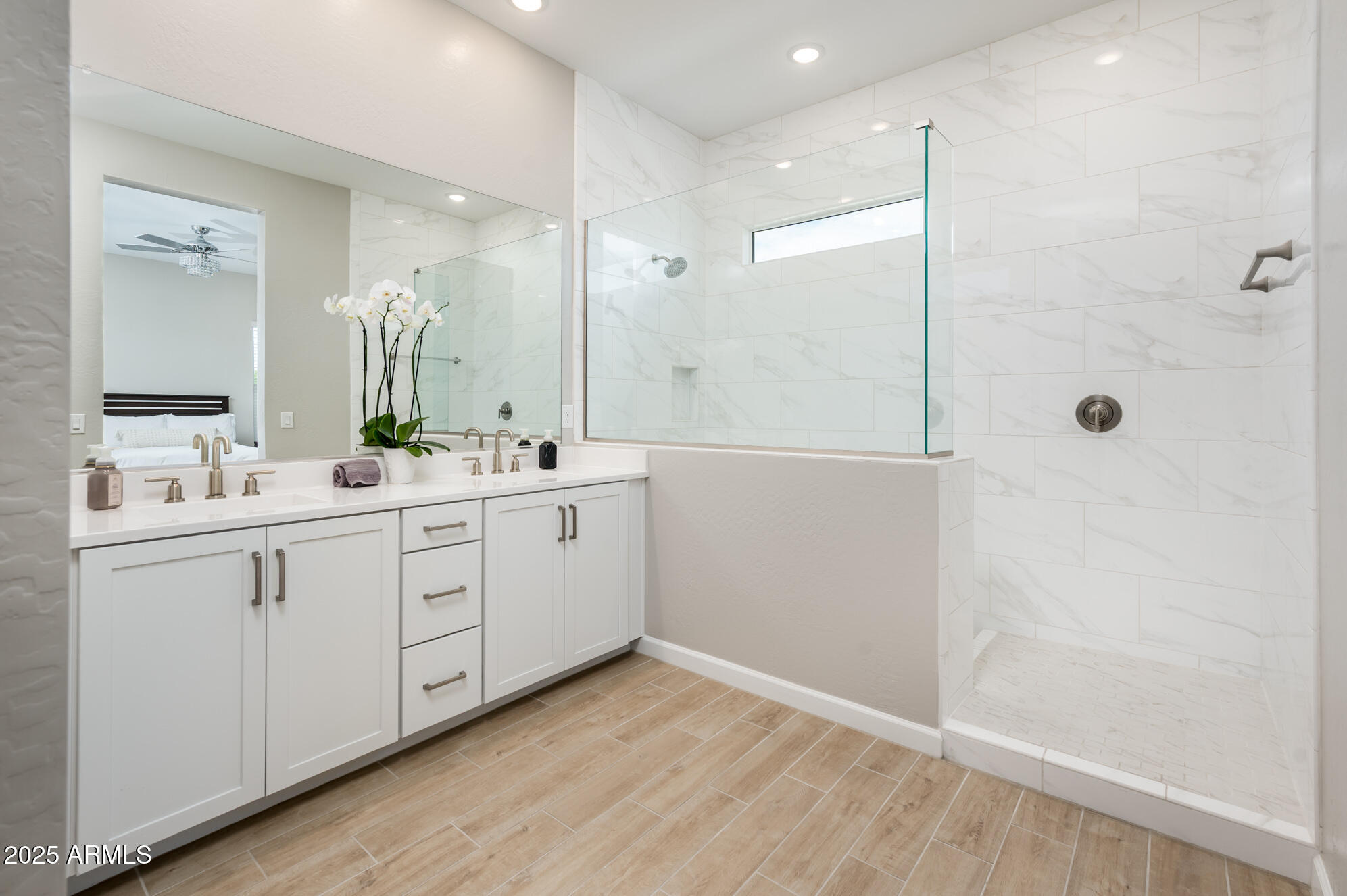 17146 North 50th Street Scottsdale, AZ 85254 - Photo 31 of 51 a bathroom with a double vanity sink a large mirror and shower