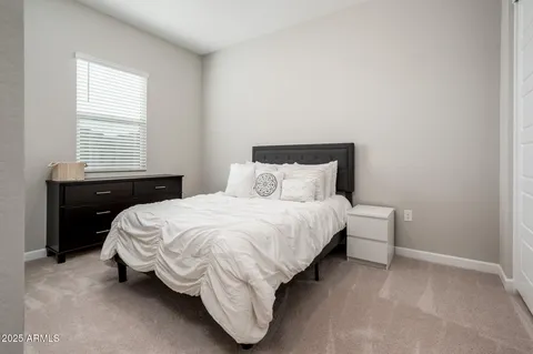 a view of a swimming pool with lawn chairs under an umbrella