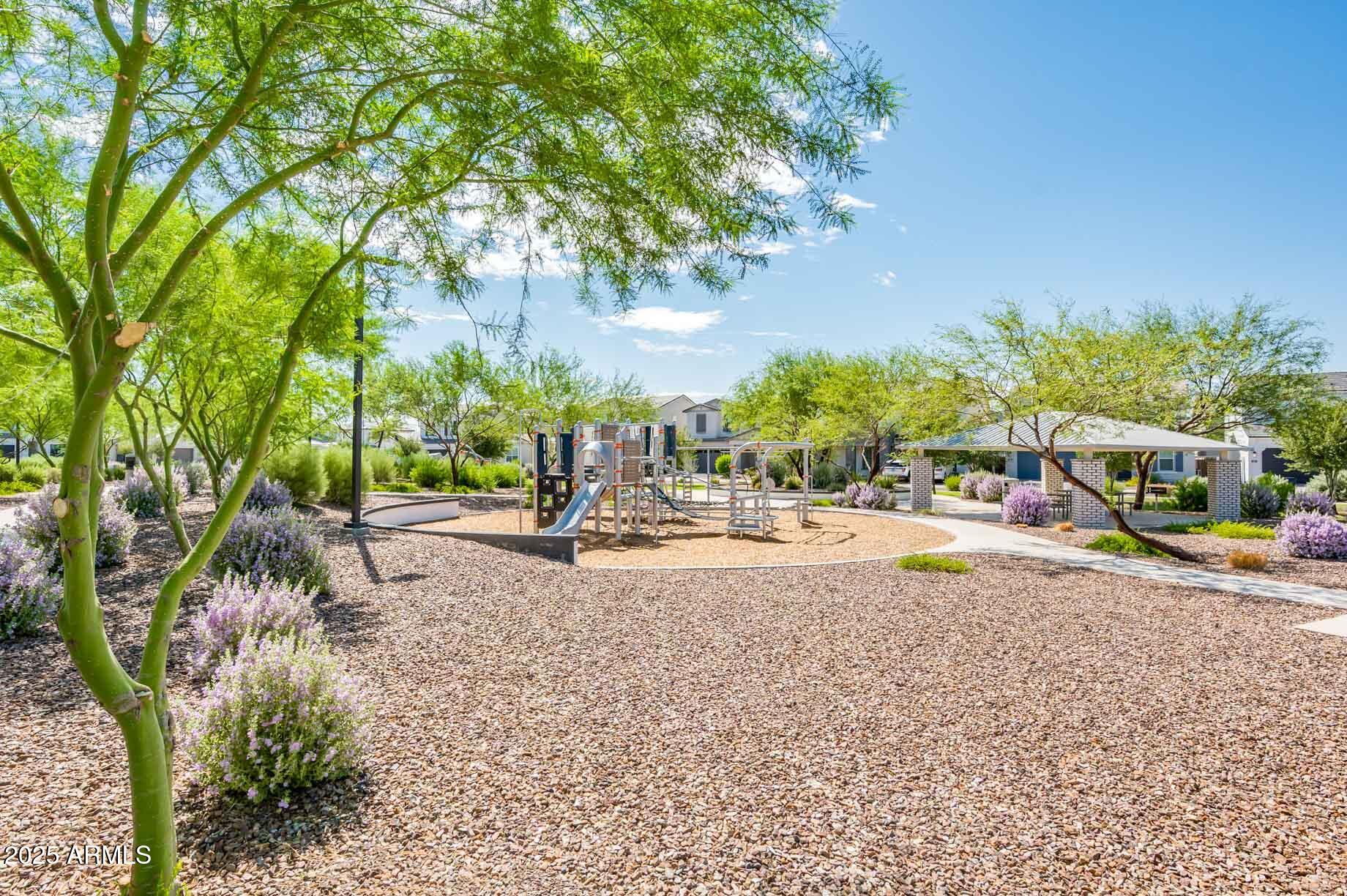 17146 North 50th Street Scottsdale, AZ 85254 - Photo 46 of 51 a view of a swimming pool with lawn chairs under an umbrella