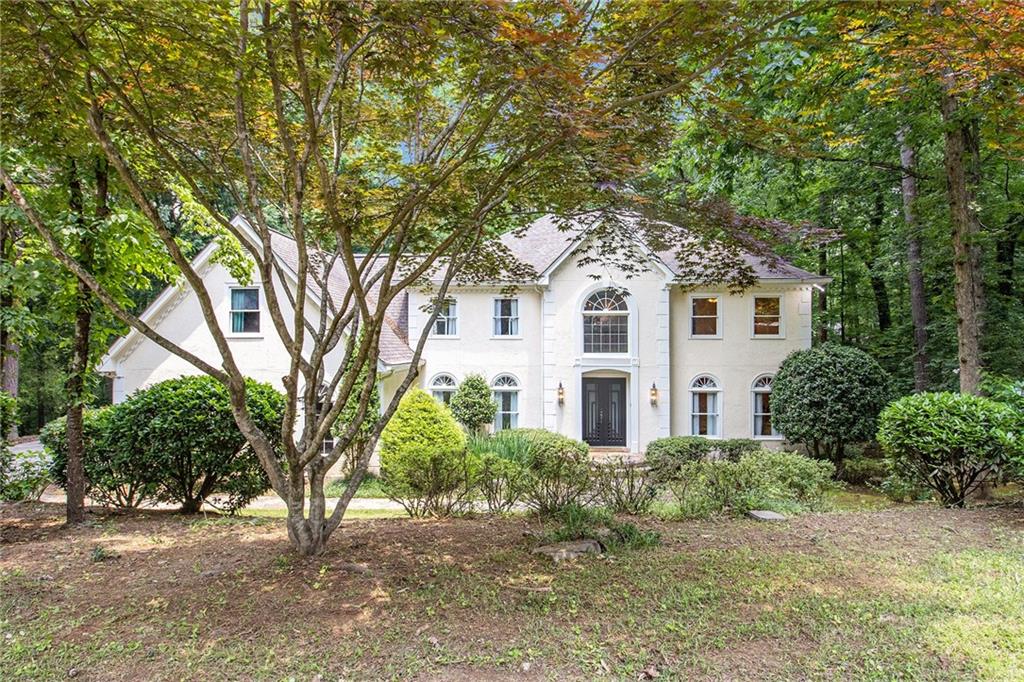 a front view of a house with a garden