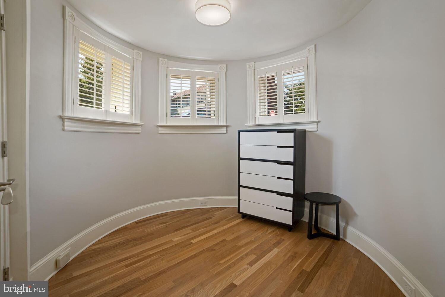 3348 Prospect Street Northwest, Unit 1 Washington, DC 20007 - Photo 12 of 16 wooden floor in an empty room with a window