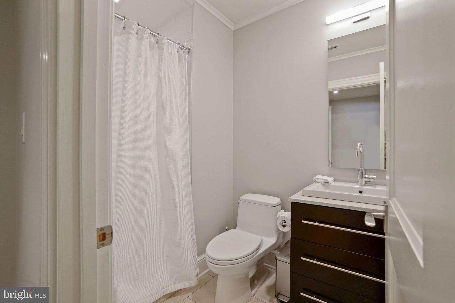 3348 Prospect Street Northwest, Unit 1 Washington, DC 20007 - Photo 13 of 16 a bathroom with a sink a toilet and shower