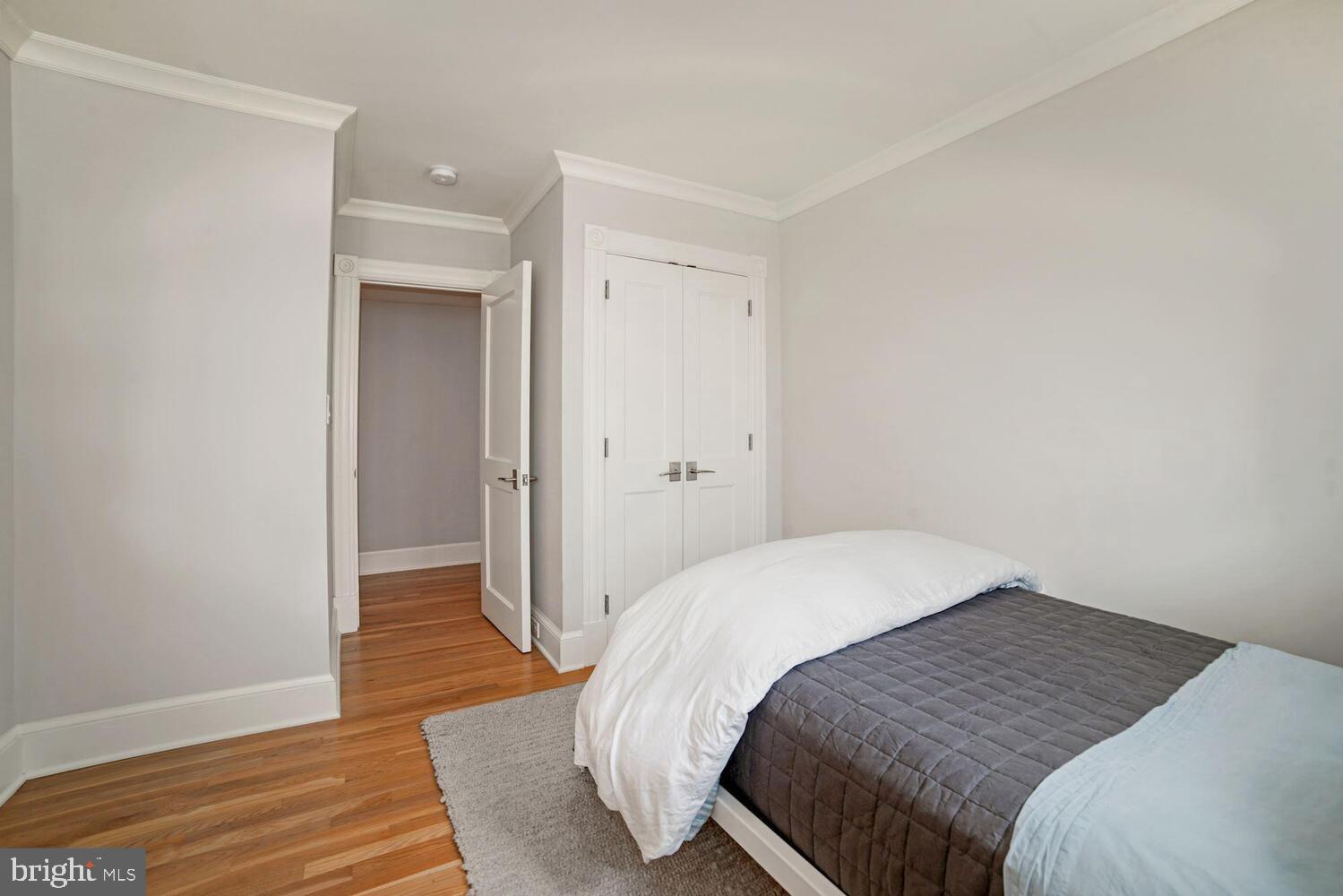 3348 Prospect Street Northwest, Unit 1 Washington, DC 20007 - Photo 9 of 16 a bedroom with a bed and wooden floor