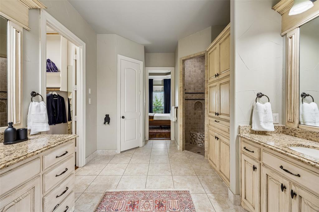 1608 Tuscan Ridge Circle Southlake, TX 76092 - Photo 19 of 36 a spacious bathroom with a double vanity sink a mirror and a shower