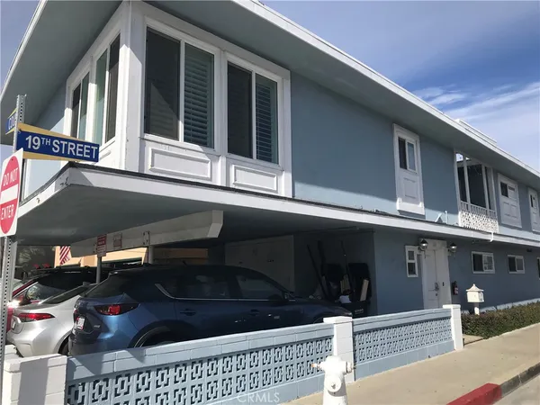 a view of a house with cars