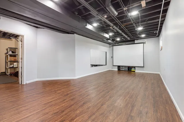 a view of a room with wooden floor