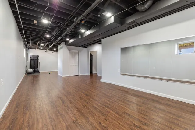 a view of empty room with wooden floor
