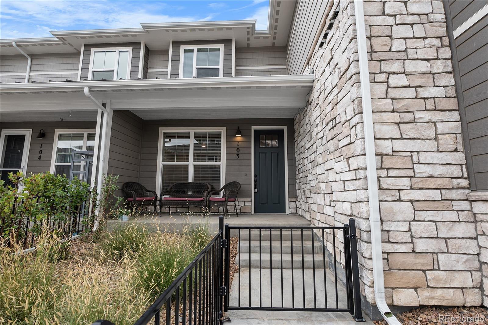 350 High Point Drive, Unit C103 Longmont, CO 80504 - Photo 1 of 25 front view of house with a bench and potted plants