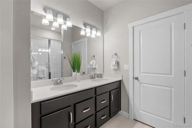 a bathroom with a double vanity sink and a mirror