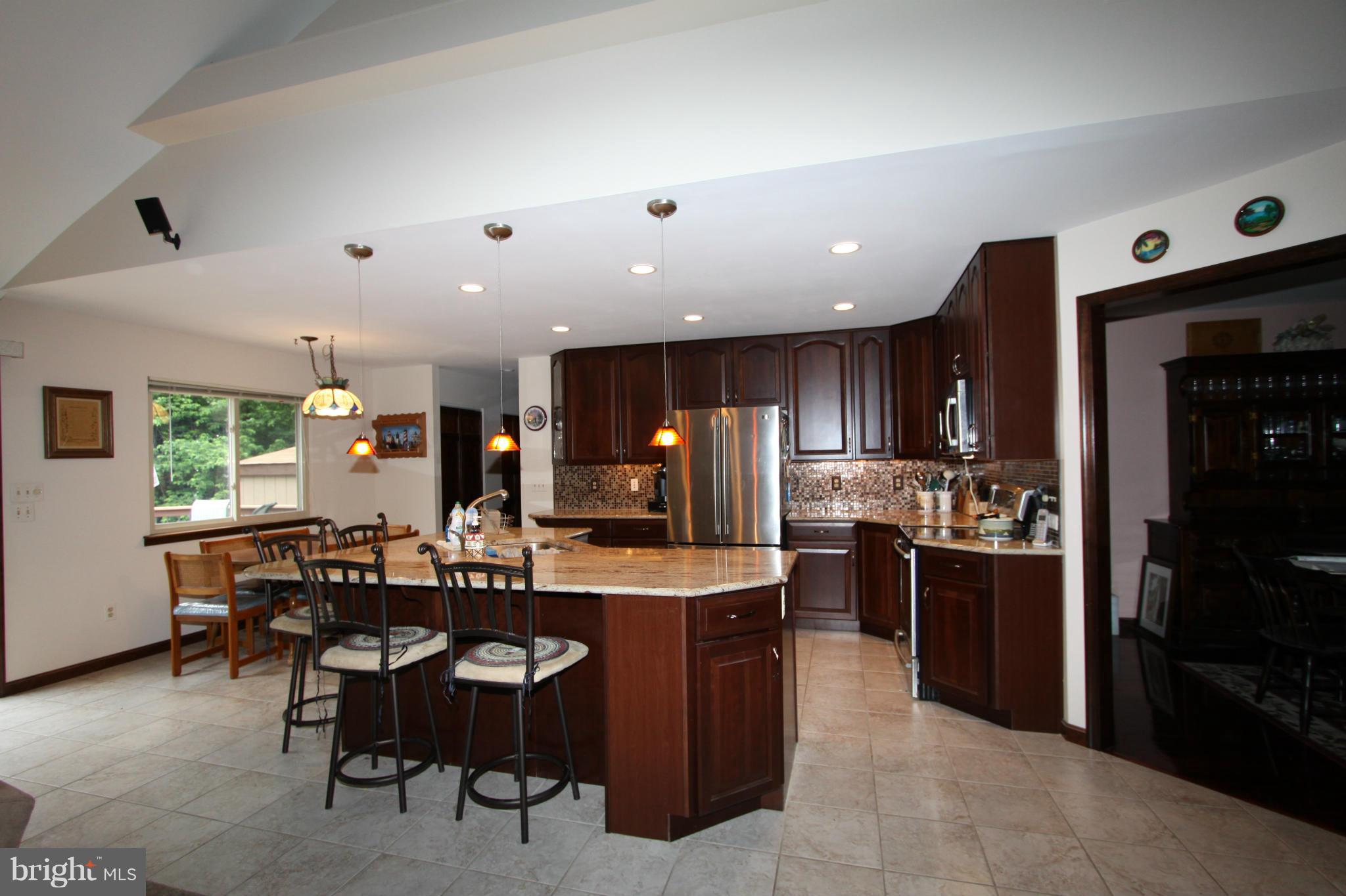 217 Burns Crossing Road Severn, MD 21144 - Photo 14 of 30 a large kitchen with stainless steel appliances lots of counter space and furniture