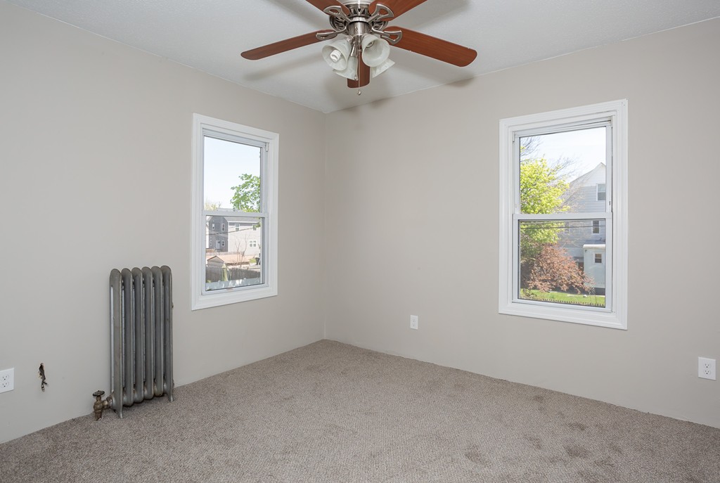 31-33 Grover Street Springfield, MA 01104 - Photo 20 of 25 an empty room with windows and fan