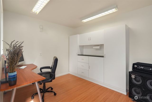a workspace with furniture and a wooden floor