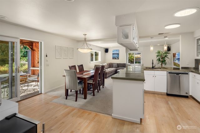 a large kitchen with a table and chairs