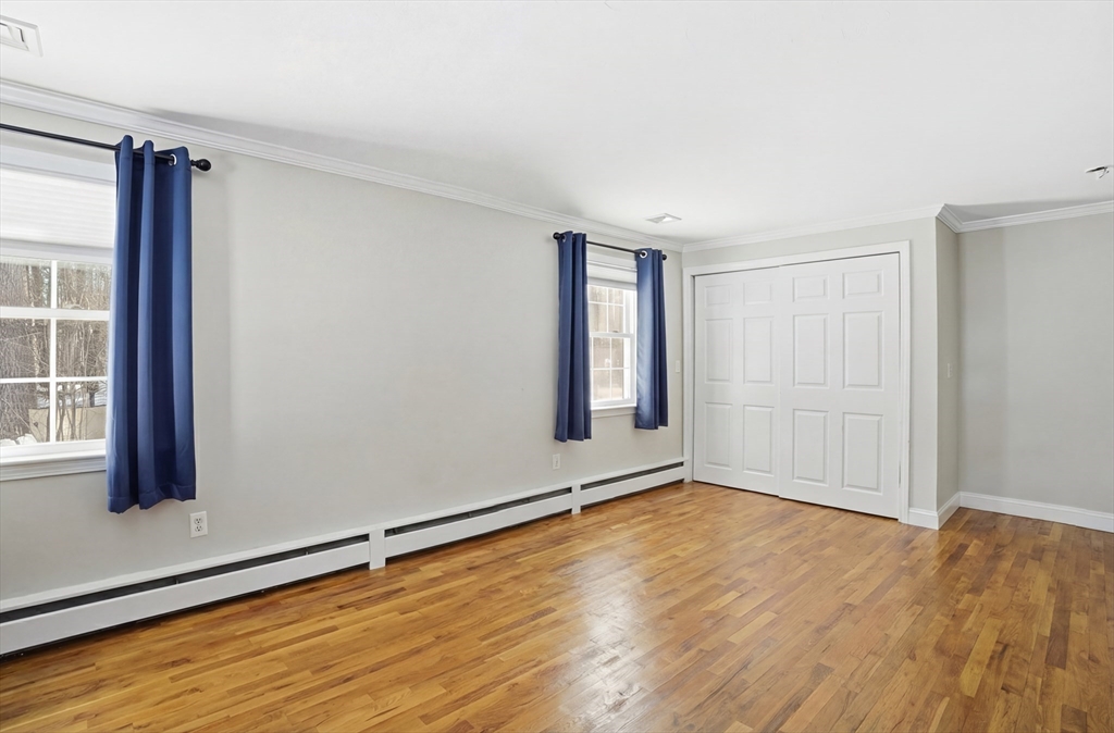 9 Kanehoe Court Townsend, MA 01474 - Photo 18 of 31 an empty room with wooden floor and windows