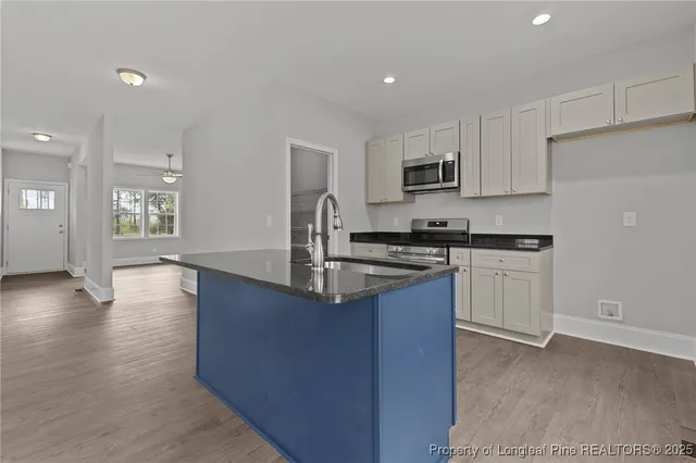 a kitchen with a sink appliances and cabinets