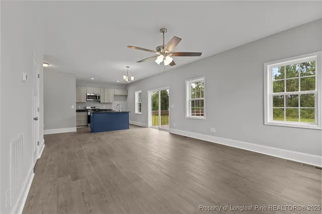 a view of empty room with a kitchen