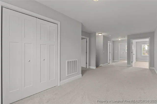 an empty room with window and ceiling fan