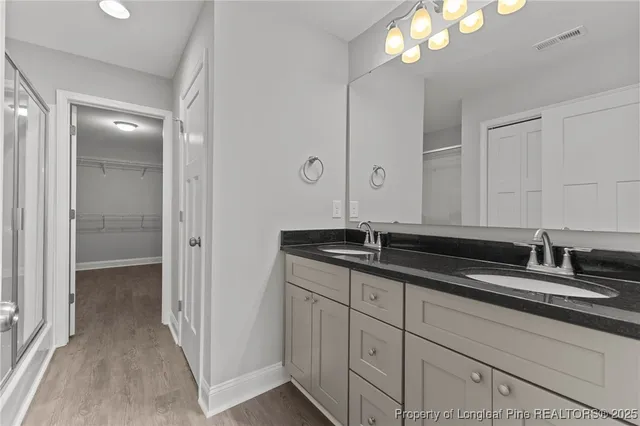 a bathroom with a glass shower door