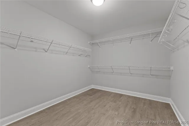 a view of a small space with wooden floor and a window