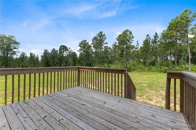 a view of a wooden deck with a yard