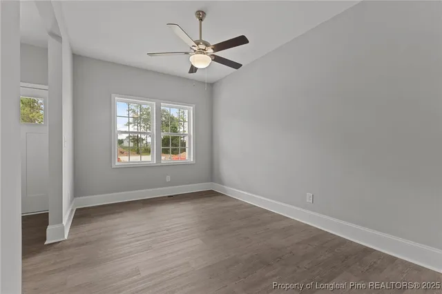 an empty room with closet and a chandelier fan