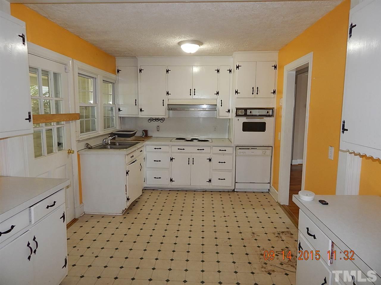 197 Thee Hester Road Roxboro, NC 27574 - Photo 5 of 16 a kitchen with a sink a stove a refrigerator and cabinets
