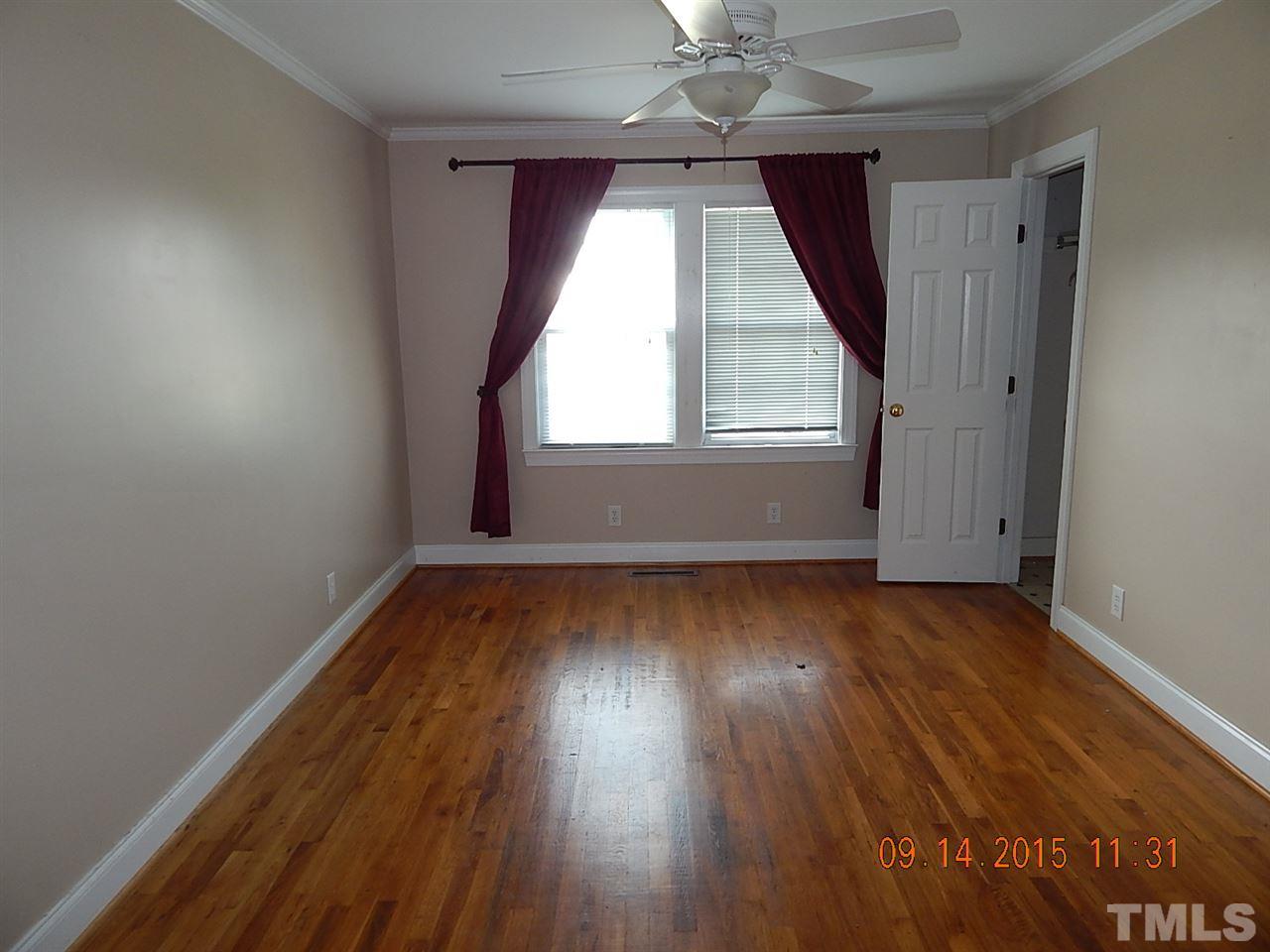 197 Thee Hester Road Roxboro, NC 27574 - Photo 7 of 16 an empty room with wooden floor and windows
