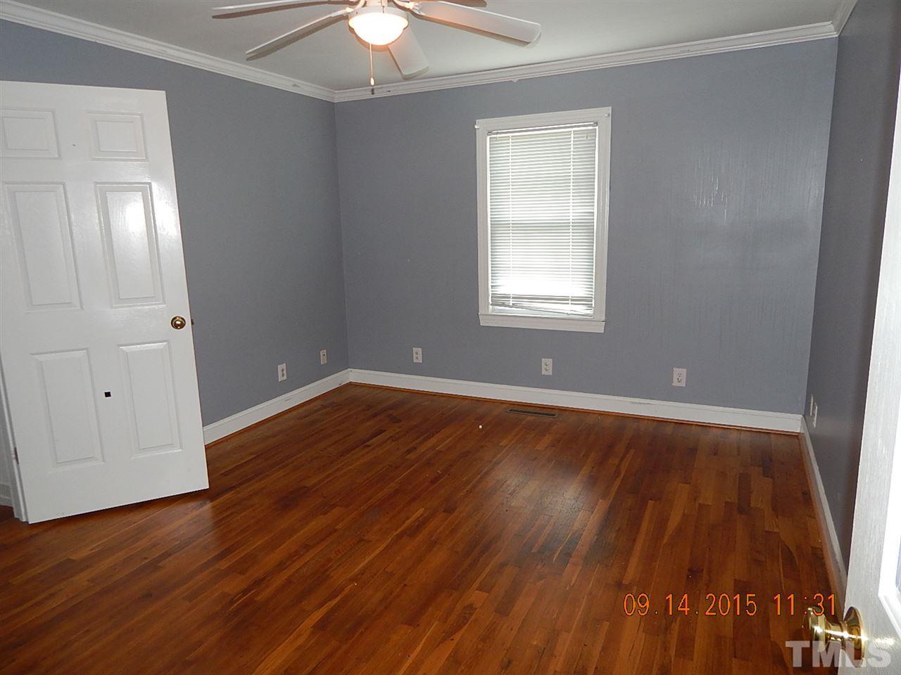 197 Thee Hester Road Roxboro, NC 27574 - Photo 8 of 16 an empty room with wooden floor and windows