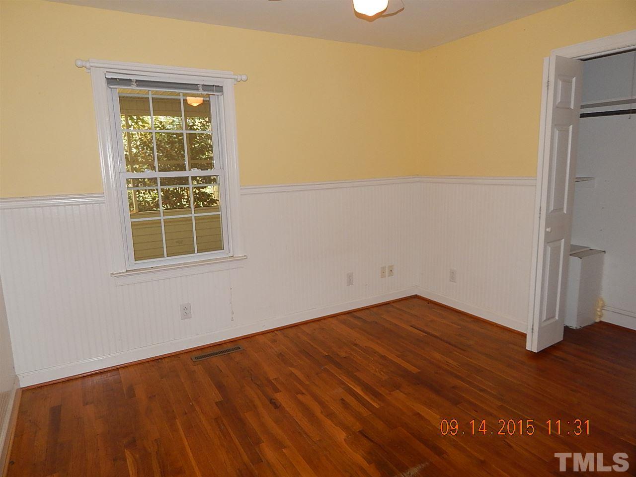 197 Thee Hester Road Roxboro, NC 27574 - Photo 9 of 16 an empty room with wooden floor and a window