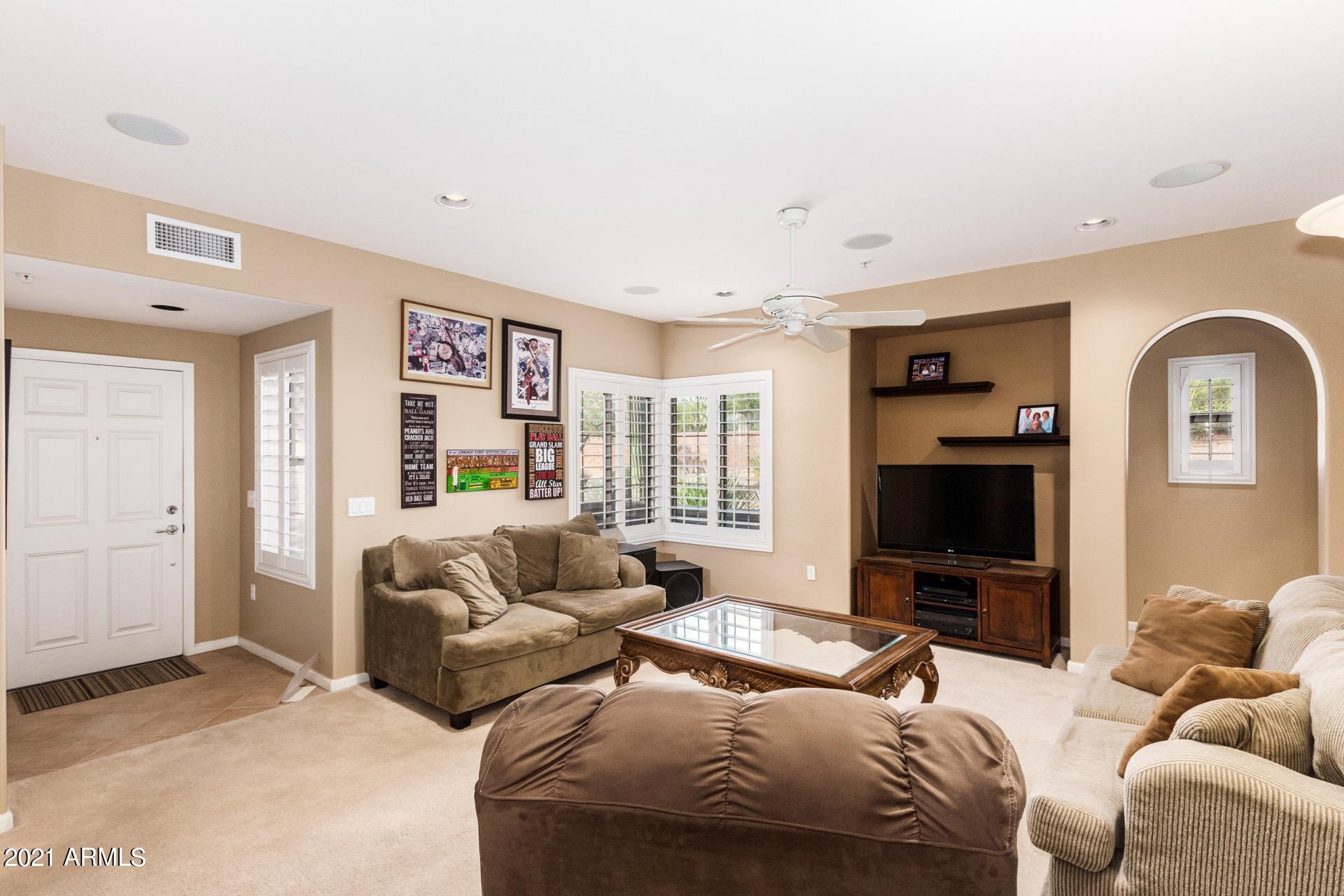 3935 East Rough Rider Road, Unit 1021 Phoenix, AZ 85050 - Photo 4 of 24 Lovely Plantation Shutters Throughout