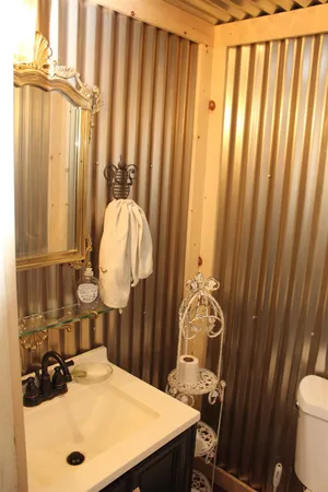 a bathroom with a sink a toilet and shower curtain