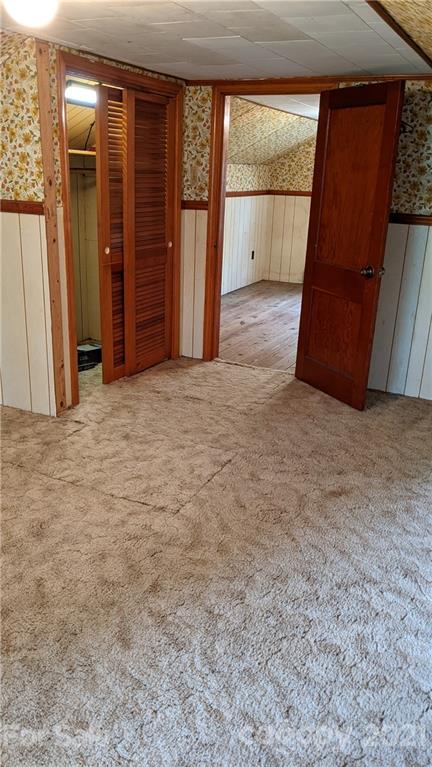 332 Jericho Road Harmony, NC 28634 - Photo 15 of 17 an empty room with sliding door and wooden floor