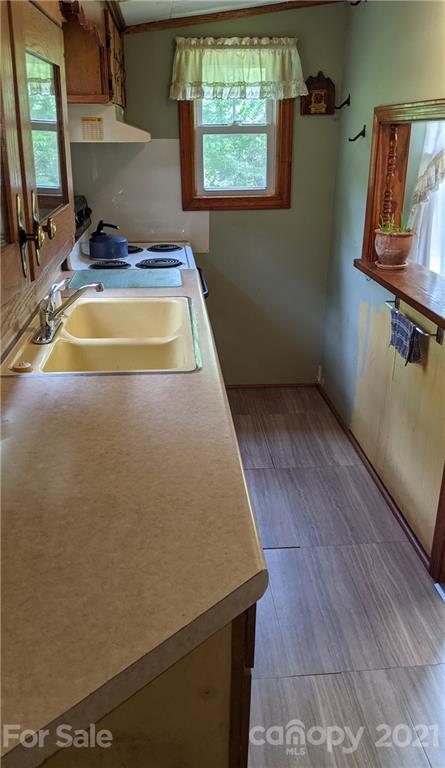 332 Jericho Road Harmony, NC 28634 - Photo 7 of 17 a view of a hall with wooden floor and a sink